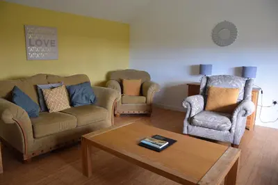 a living room with two couches and a coffee table at The Byre at Drumachro in Isle of Gigha