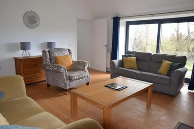 a living room with a couch and a coffee table at The Byre at Drumachro in Isle of Gigha