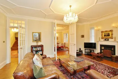 a living room with a couch and a table at Elegant 3-Bedroom Ramsay Garden Apartment in Edinburgh City Centre in Edinburgh