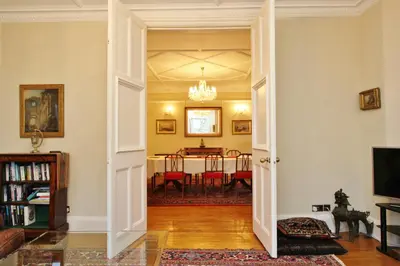 a living room with a dining room table at Elegant 3-Bedroom Ramsay Garden Apartment in Edinburgh City Centre in Edinburgh