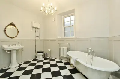 a bathroom with a tub and a sink and a toilet at Elegant 3-Bedroom Ramsay Garden Apartment in Edinburgh City Centre in Edinburgh