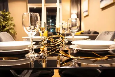 a dining room table with wine glasses on it at VCity ApartHotels Glasgow Central in Glasgow