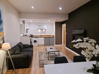 a living room with a couch and a table at VCity ApartHotels Glasgow Central in Glasgow