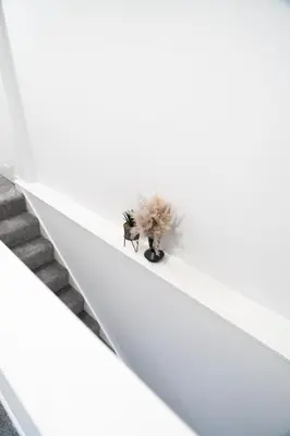 a plant sitting on the side of a stairs at Bell Apartment in Airdrie