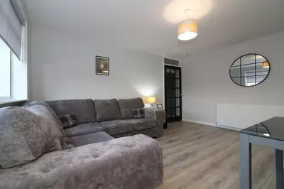 a living room with a couch and a table at Signature - Glen Garry House in East Kilbride