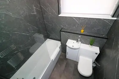 a bathroom with a toilet and a sink and a tub at Signature - Glen Garry House in East Kilbride