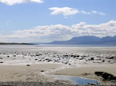 a large body of water with mountains in the background at Beautiful spacious old schoolhouse with stunning sea views and beach nearby in Port Bannatyne
