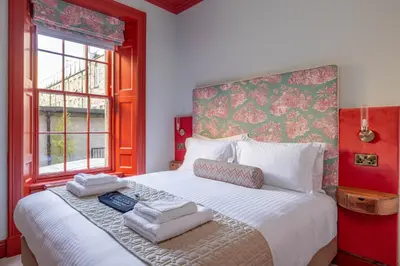 a bedroom with a large bed with towels on it at Eleven Stafford Street Townhouse in Edinburgh