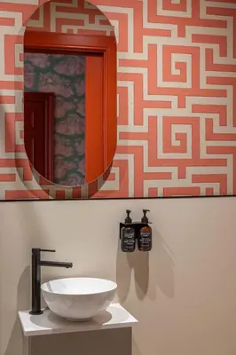 a bathroom with a sink and a mirror at Eleven Stafford Street Townhouse in Edinburgh