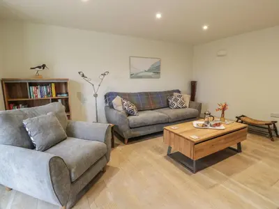 a living room with two couches and a coffee table at Thorneydyke Cottage in Stirling
