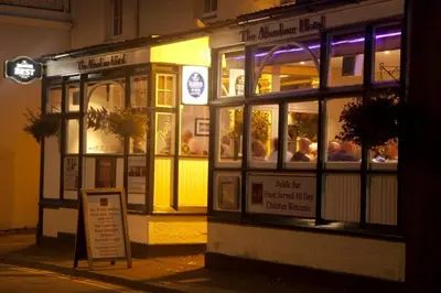 a store front of a restaurant at night at Aberdour Hotel, Stables Rooms & Beer Garden in Aberdour