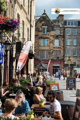 a group of people sitting at tables in a city at Lady Wynd - 1 bed apartment in Edinburgh
