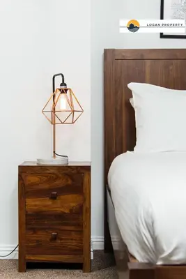 a lamp on a night stand next to a bed at Lady Wynd - 1 bed apartment in Edinburgh