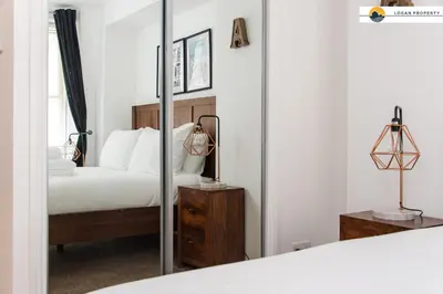 a bedroom with a bed and a mirror at Lady Wynd - 1 bed apartment in Edinburgh