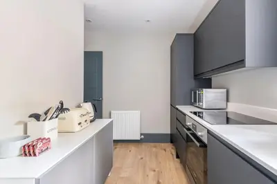 a kitchen with white counters and a counter top at Immaculate 3 Bed Apartment with Private Entrance in Inverleith in Edinburgh