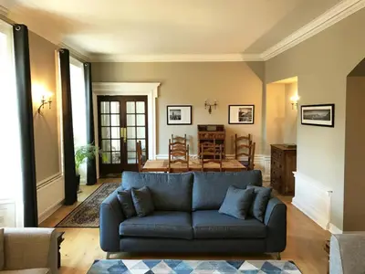 a living room with a blue couch and a table at Edlets - Frederick Street Apartment in Edinburgh