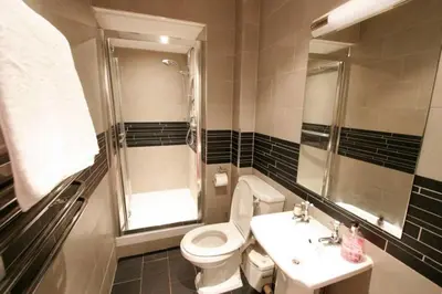 a bathroom with a toilet and a sink and a shower at Edlets - Frederick Street Apartment in Edinburgh