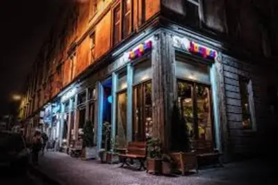 a store front of a building at night at Glasgow, Finnieston Luxury 2 Bed with parking, e-check in, hi-fi in Glasgow