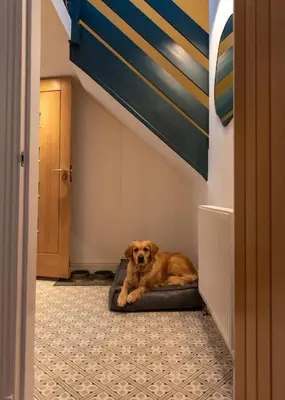a dog laying on a dog bed in a hallway at The Stylish 3-Bedroom Maisonette Retreat in Stirling