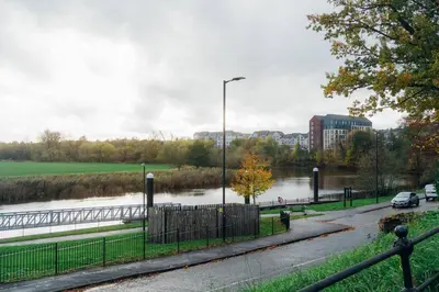 a flooded street with a river and a street light at James Street 2 Bedroom Apartment in Stirling