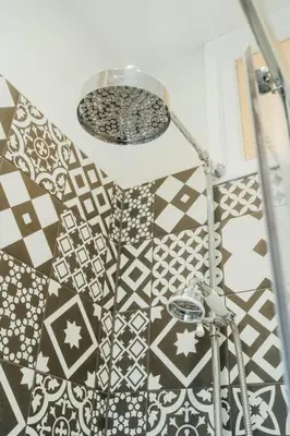 a room with a shower with a lamp and tiles at James Street 2 Bedroom Apartment in Stirling