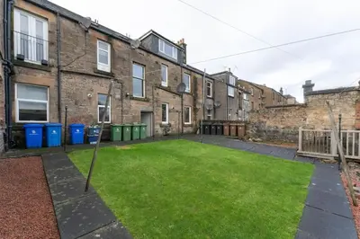 an empty yard in front of a brick building at James Street 2 Bedroom Apartment in Stirling