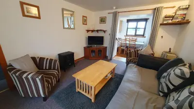 a living room with a couch and a coffee table at Rhumhor in Bunessan