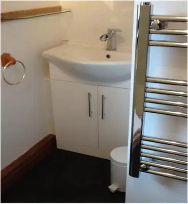 a bathroom with a white sink and a toilet at Rhumhor in Bunessan