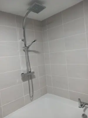 a shower with a shower head in a bathroom at Couple's Retreat-West Kilbride in Seamill