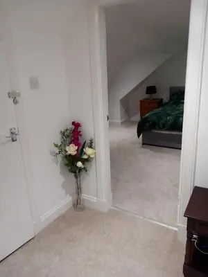a hallway with a vase of flowers in a room at Couple's Retreat-West Kilbride in Seamill