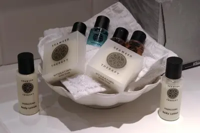 a group of bottles of soap and towels in a bowl at Holiday Inn - Glasgow Airport by IHG in Paisley