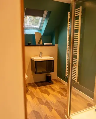 a bathroom with a sink and a mirror at Cairn Cottage in Onich