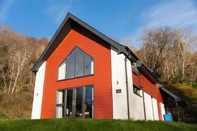 a red and white house on top of a hill at Cairn Cottage in Onich