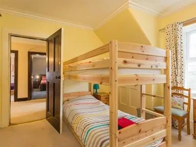 a bunk bed in a room with yellow walls at 5 Bed in Brodick CA016 in Brodick