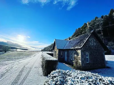 an old stone house on a snowy road at The Lodge in Lochgilphead