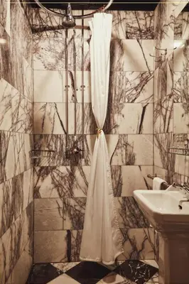 a bathroom with a shower curtain and a sink at House of Gods Glasgow in Glasgow