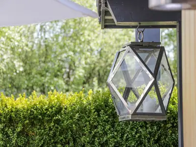 a glass lantern hanging from a house at Shepherdess Cottage in Moffat
