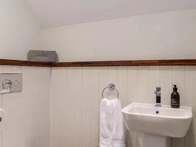 a bathroom with a sink and a white towel at The Old Mill in Linlithgow