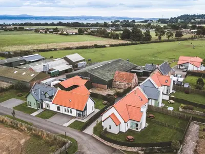 an aerial view of a group of houses with orange roofs at The Old Mill in Linlithgow