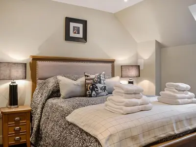 a bedroom with two beds with white pillows on it at The Old Mill in Linlithgow