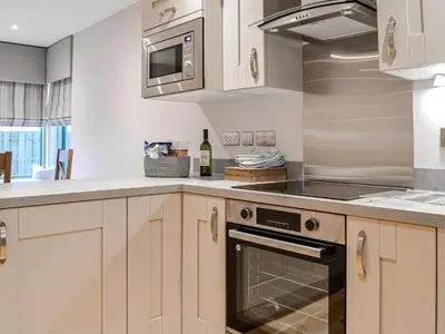 a kitchen with white cabinets and a stove top oven at Pride Of Erin - Uk45929 in Linlithgow