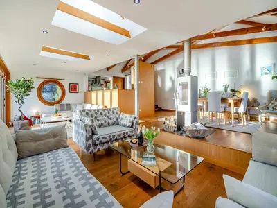 a living room with a couch and a table at Shore House in Kilcreggan