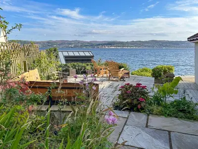a patio with a view of the water at Shore House in Kilcreggan