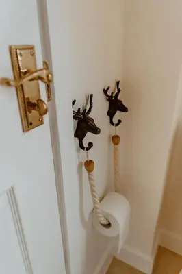 a bathroom with a toilet with some animals on the wall at Whisky Whispers Hunters Quay in Sandbank