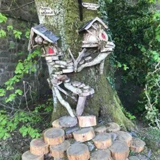 a tree stump with a bird house on it at Alderdale B&B in Luss