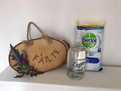 a shelf with a bottle of milk and a bottle of water at Alderdale B&B in Luss