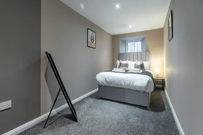 a small bedroom with a bed and a window at Broom Cottage in Lanark