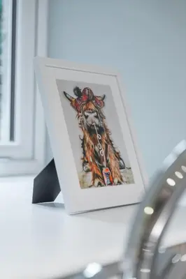 a picture of a cow in a picture frame on a table at Broom Cottage in Lanark