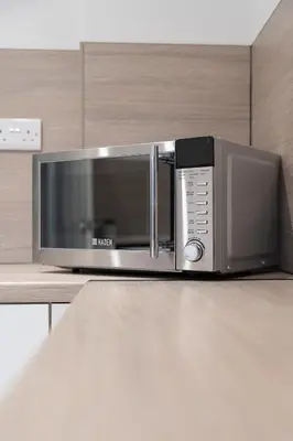 a microwave oven sitting on top of a counter at Kirkview Apartment in Kirk of Shotts