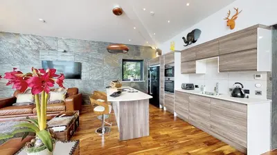 a kitchen and living room with a couch and a table at Cameron North Lodge in Alexandria